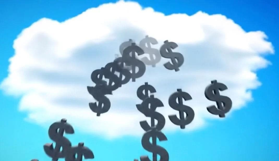 Dollar signs raining from cloud on blue sky background