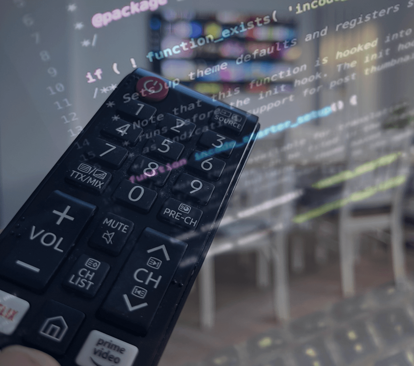Hand with remote control in foreground, overlayed with faded software code